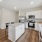 Island style kitchen with stainless steel appliances and natural stone counter tops